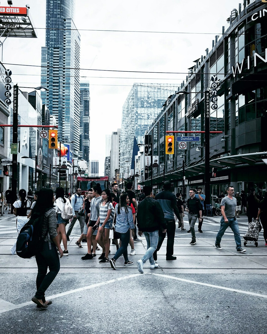 Pedestrians crossing a busy downtown Toronto intersection